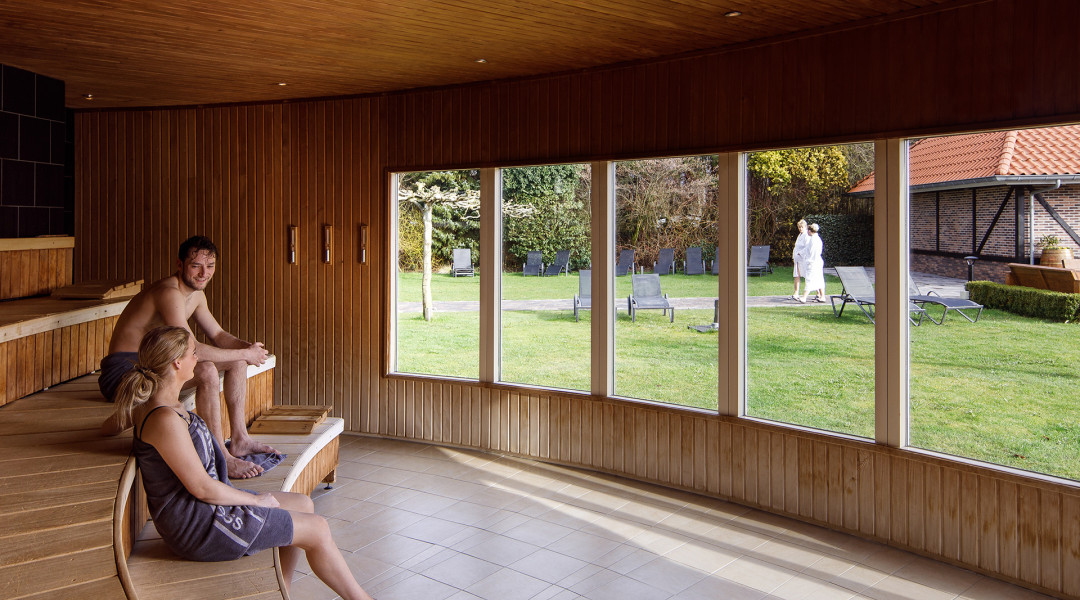 Man en vrouw in panoramasauna genieten en ontspannen